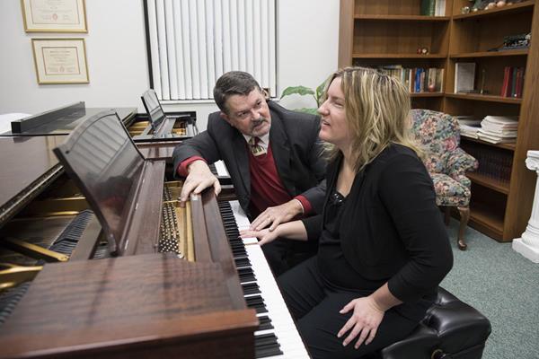 Dr. Chuck Clevenger teaches Macy McClain how to play the piano during the Fall 2017 semester at Cedarville University. Photo by Scott Huck