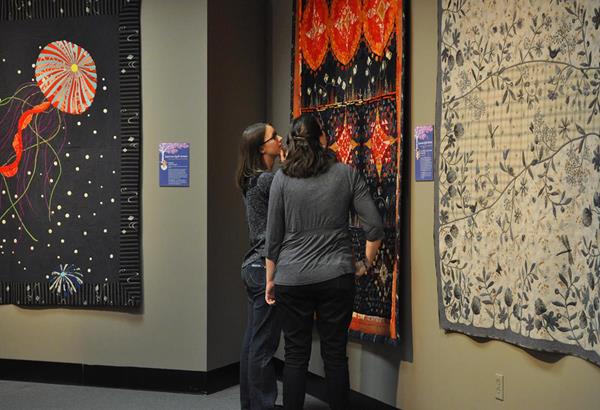 Two visitors experience the exhibit "Japanese Quilt Artists that Influenced the World" at The National Quilt Museum.