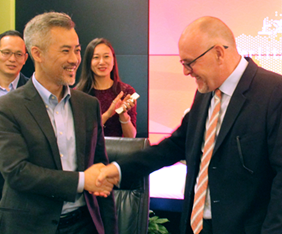 Mr. Zheng Teng and Chris Eden shake hands after signing an agreement to bring Berlitz Kids & Teens English-language centers to China.