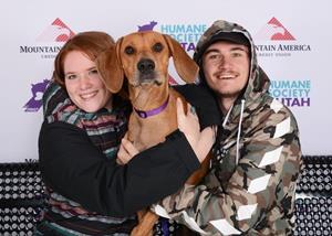 Adopters pose with their new dog at the “Fall in Love Adoption Special” event. 
