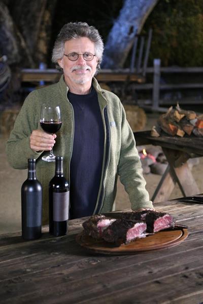 Steven Raichlen raises a glass before enjoying his pastrami beef ribs on the set of the new TV series, Project Fire.