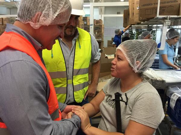 Dinant President Miguel Mauricio Facusse with a vision-impaired employee at the Dixie snacks factory in San Pedro Sula.