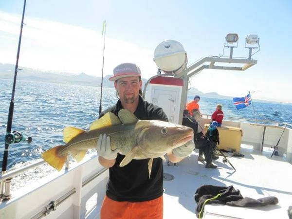 Guests on International Expeditions' Iceland tour enjoy cod fishing with locals. 