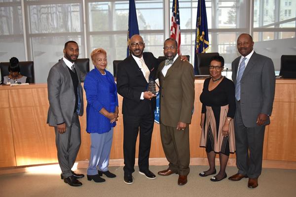 Dr. David Clark, CEO, Chester Community Charter School (left center), receiving honorary award from Thaddeus Kirkland, Mayor of Chester, PA (right center) and members of Chester City Council. 