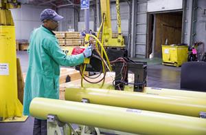 An Aerojet Rocketdyne Camden employee prepares a solid rocket motor for shipment