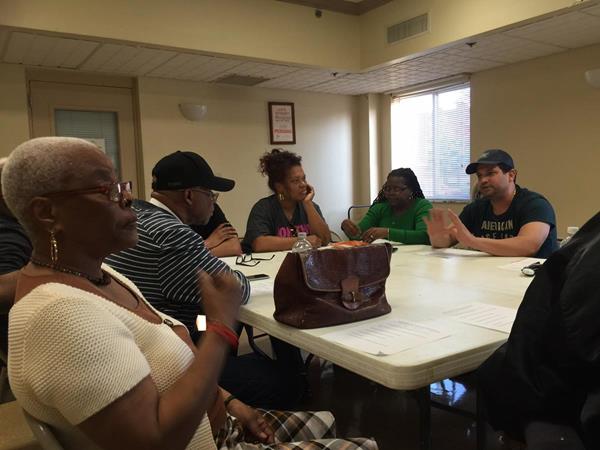 Luis Gomez Martinez (far right) is shown during a recent meeting with the board members and officers of Richard Allen New Generation (RANG), as they worked on details of the new, wide-ranging community support agreement between Martinez’ Polo Supermarket, at 10th and Brown Streets, in North Central Philadelphia, and members of the community.