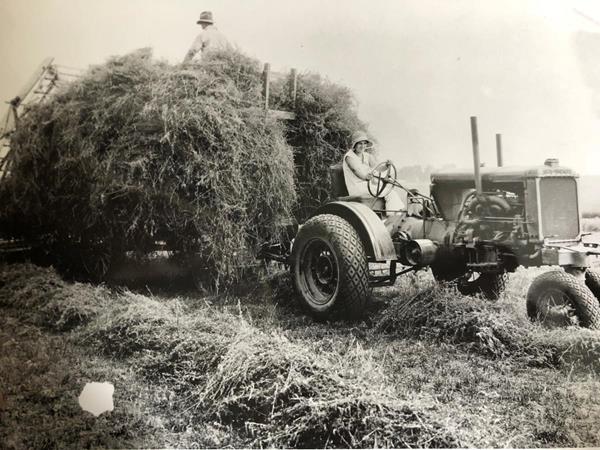 An Allis Chalmers tractor in a hayfield on an Illinois Farm - circa 1933. Off-road equipment has evolved since the early days of farming and construction. 