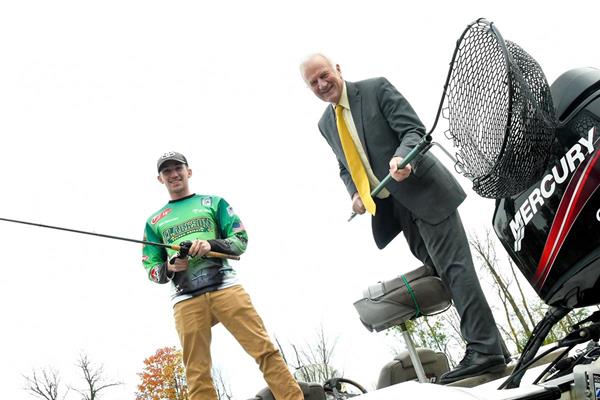 Benjamin Seaman ’19, president of the Clarkson Bass Fishing Club and Clarkson President Tony Collins.