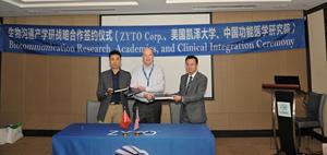 Dr. Vaughn Cook signing Agreement with Gavin Chen and Dr. Shaoqing Li