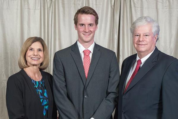 Dave and Phyllis Graurer stand with a Cedarville University pharmacy student during an awards program.