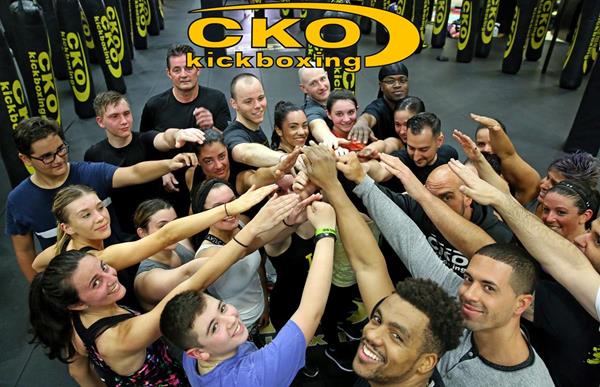 A CKO Kickboxing team celebrating their positive individual achievements as a united community.