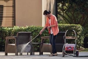 Woman cleaning patio