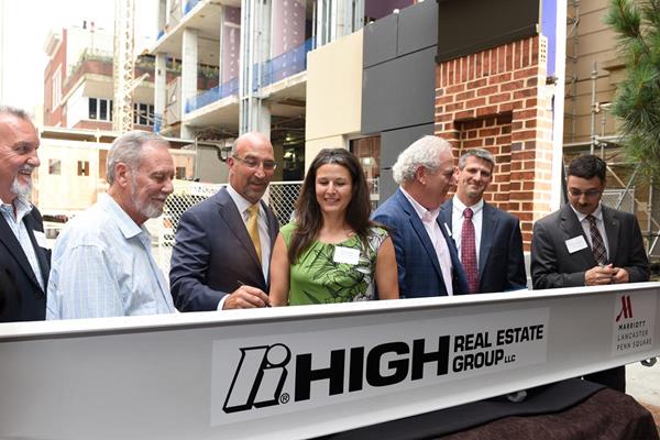 Community and business leaders sign a ceremonial final beam for the $39.4 million East Tower expansion of the Lancaster Marriott at Penn Square. L-R: Randall Horst, Chair, Redevelopment Authority of the City of Lancaster; S. Dale High, Chair Emeritus, High Companies; Mark Fitzgerald, President and COO, High Real Estate Group LLC; Mayor Danene Sorace, City of Lancaster; Robert Krasne, Chairman and CEO, Steinman Communications; Mike Shirk, CEO, High Companies; Ray D'Agostino, Chair, Lancaster City Revitalization and Improvement Zone (CRIZ) Program.