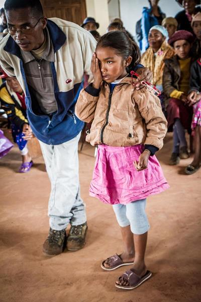 Malagasy girl getting a visual acuity test during an outreach screening in her village.