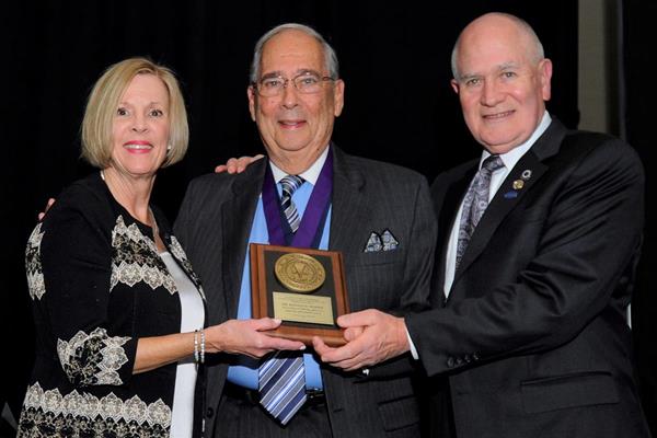 Dr. Woody, center, with ACP Immediate Past President Dr. Susan E. Brackett, left, and Dr. John Agar, right, who nominated Dr. Woody for the award