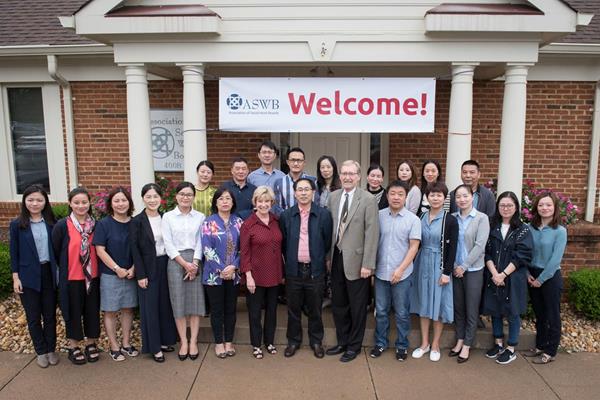 A delegation of social workers from Hangzhou City, China, visited ASWB headquarters in Culpeper, Virginia. At center, Mr. Huamin Cheng, deputy director general of the Hangzhou Municipal Civil Affairs Bureau, China, stands with ASWB Chief Executive Officer Mary Jo Monahan and ASWB Chief Operating Officer Dwight Hymans.